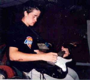 Christopher making love to his guitar.jpg